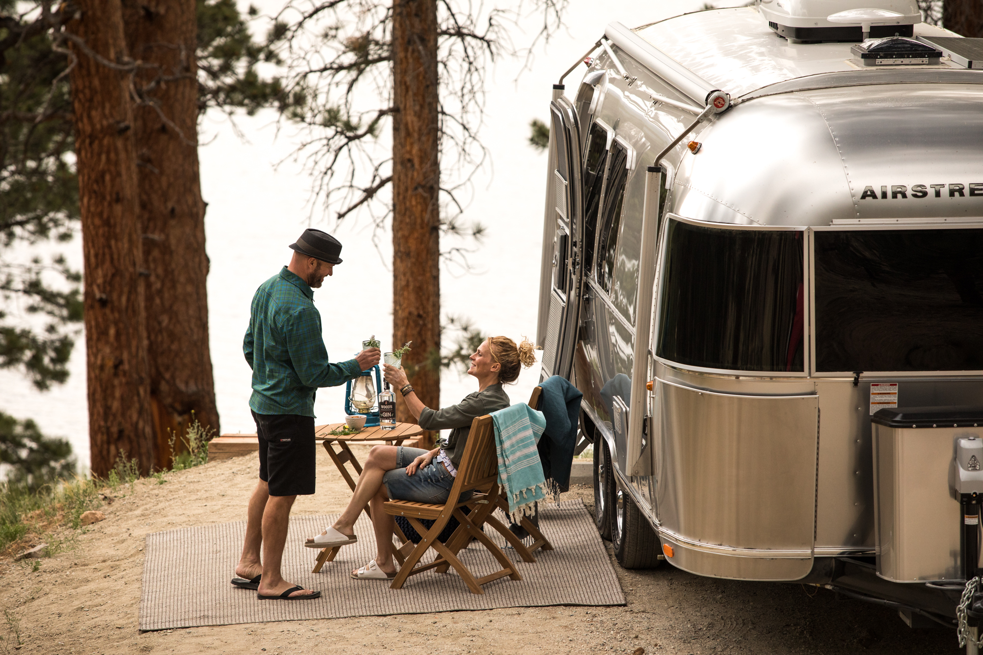 Airstream at a lakeside camp at dusk