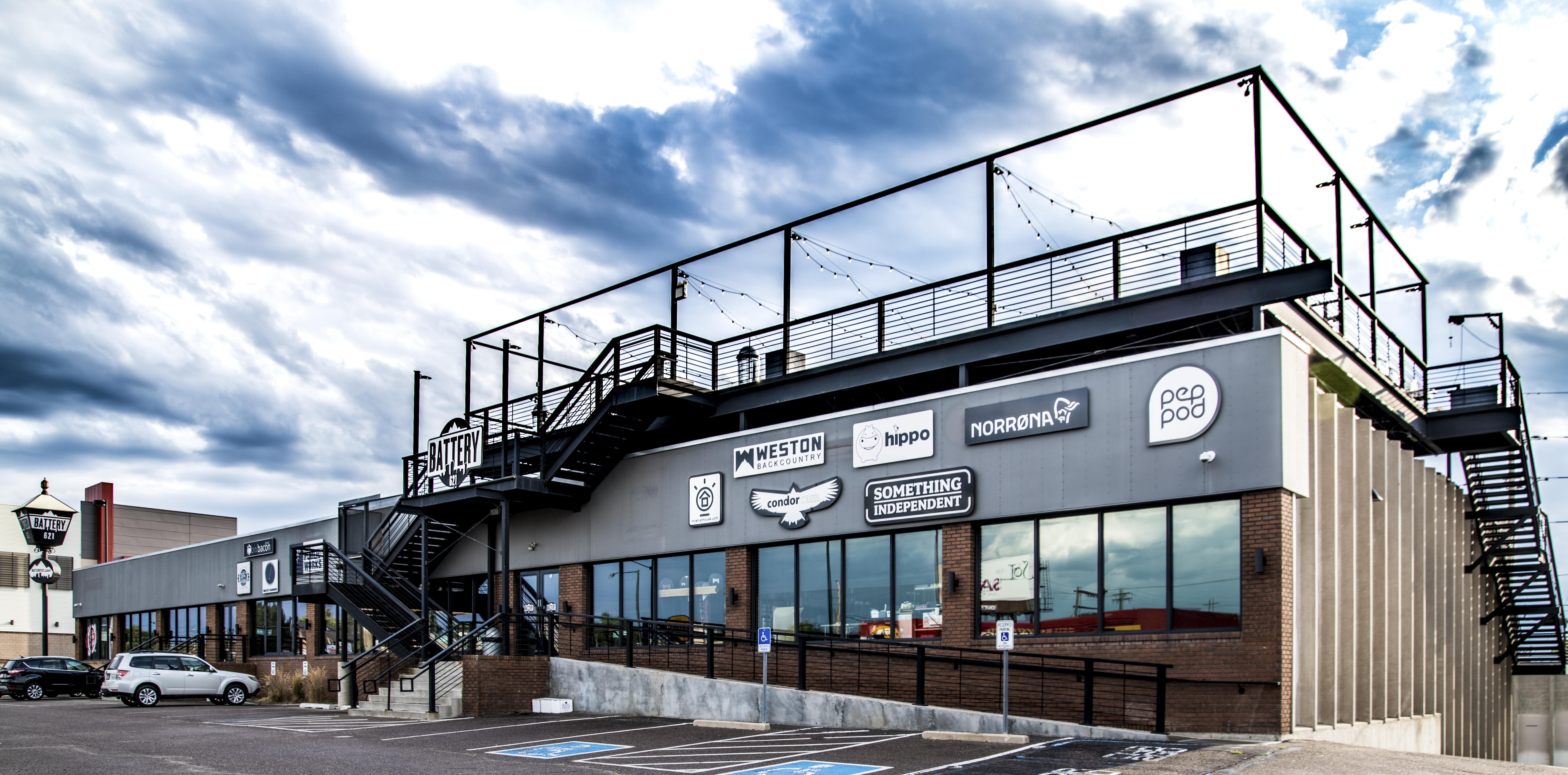 Battery621 building exterior with tenant brand signage and rooftop deck