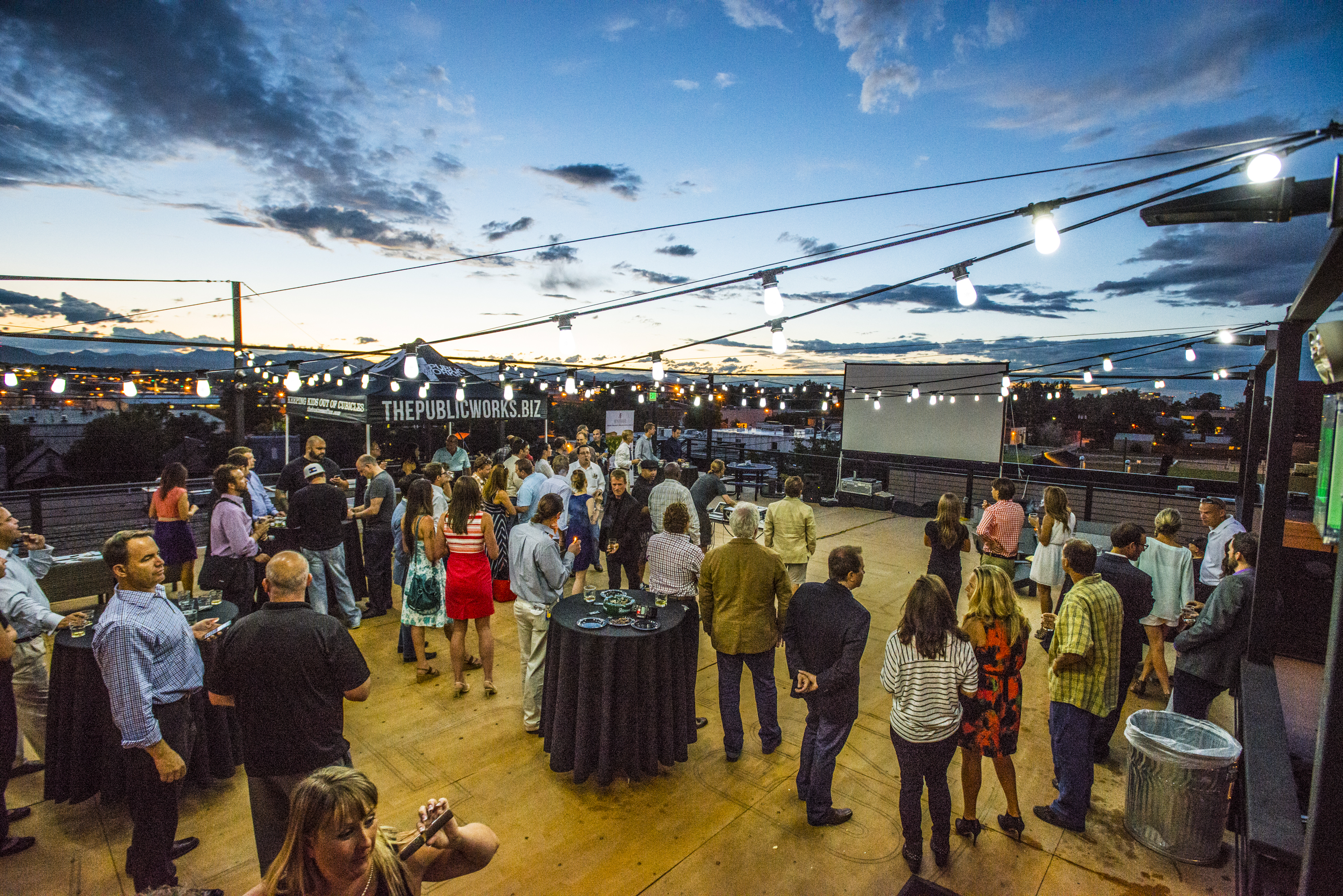 Evening rooftop party under string lights at Battery621