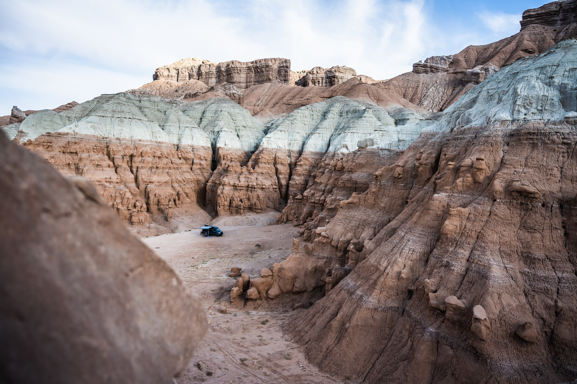 Overlanding camp tucked into colorful desert badlands